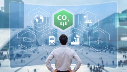 man views screen of CO2 reduction against background of net zero buildings